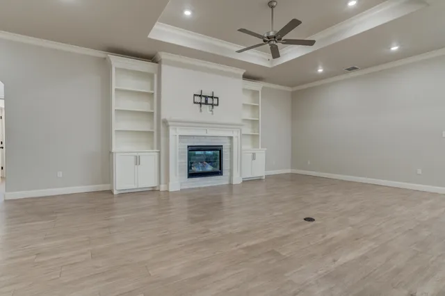 wooden floor in an empty room with a fireplace