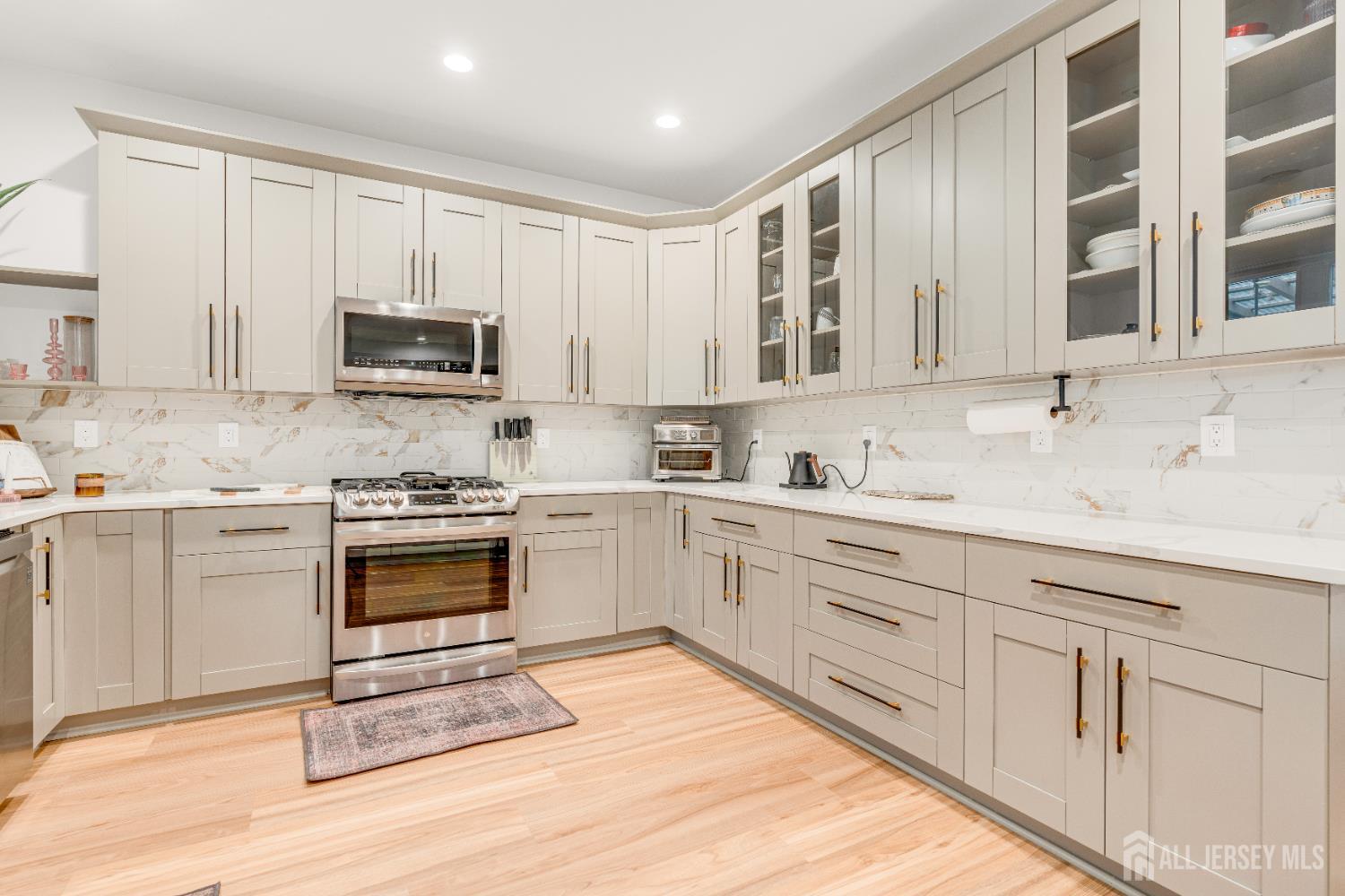 38 Sturgis Road Edison, NJ 08817 - Photo 13 of 41 a kitchen with stainless steel appliances granite countertop a stove a sink and a microwave