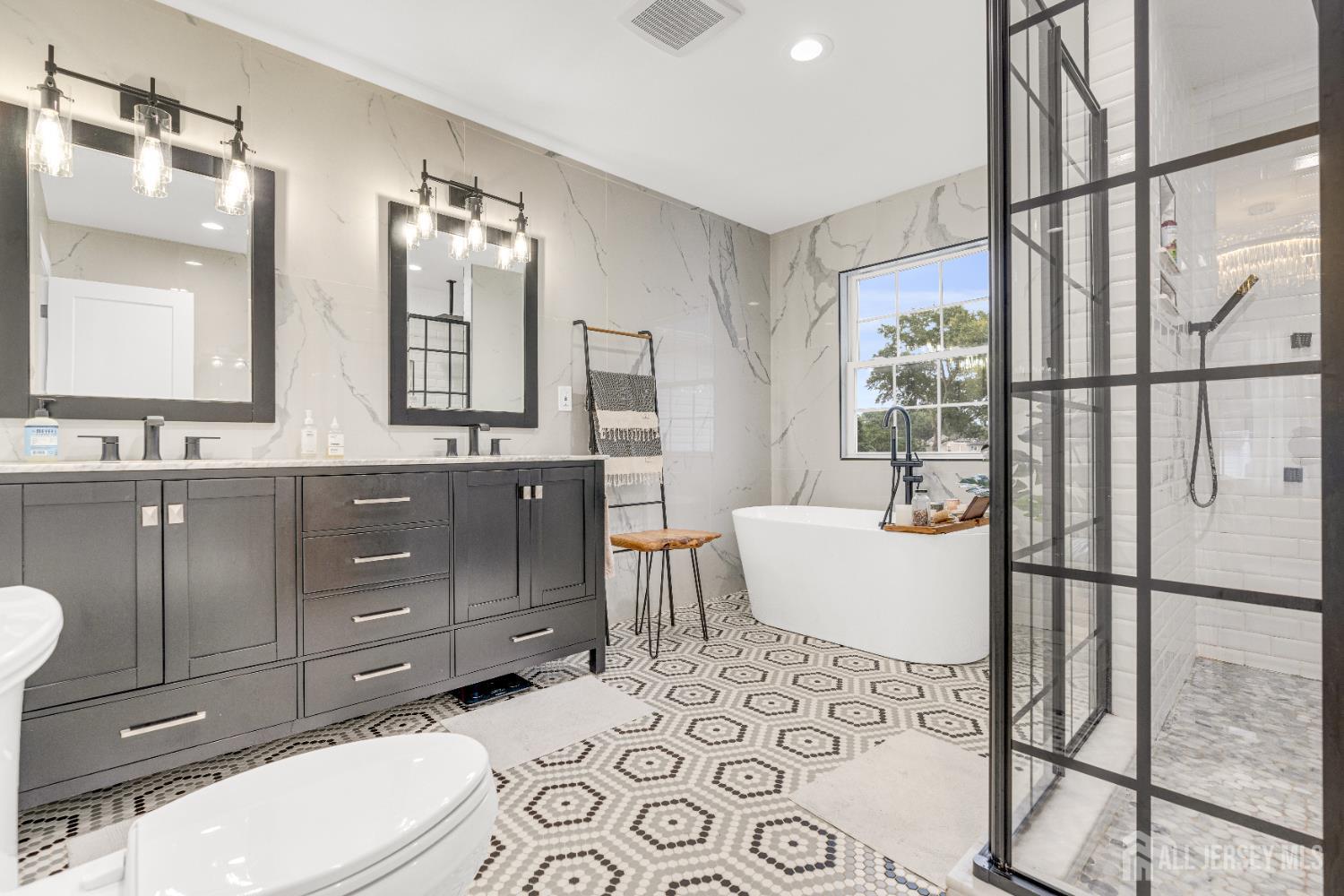 38 Sturgis Road Edison, NJ 08817 - Photo 24 of 41 a bathroom with a toilet a sink and mirror