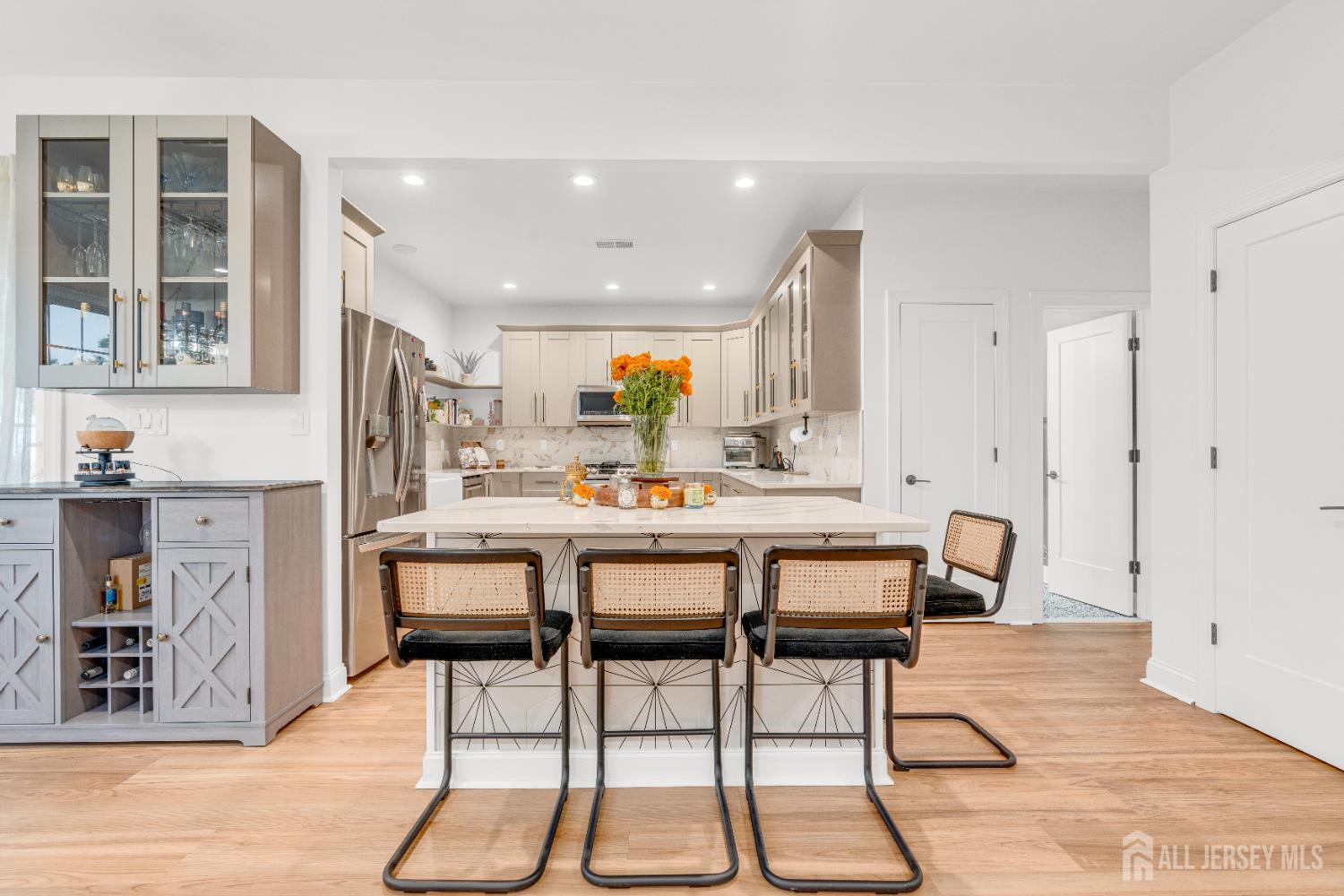 38 Sturgis Road Edison, NJ 08817 - Photo 10 of 41 a dining hall with stainless steel appliances kitchen island granite countertop a dining table and chairs with wooden floor