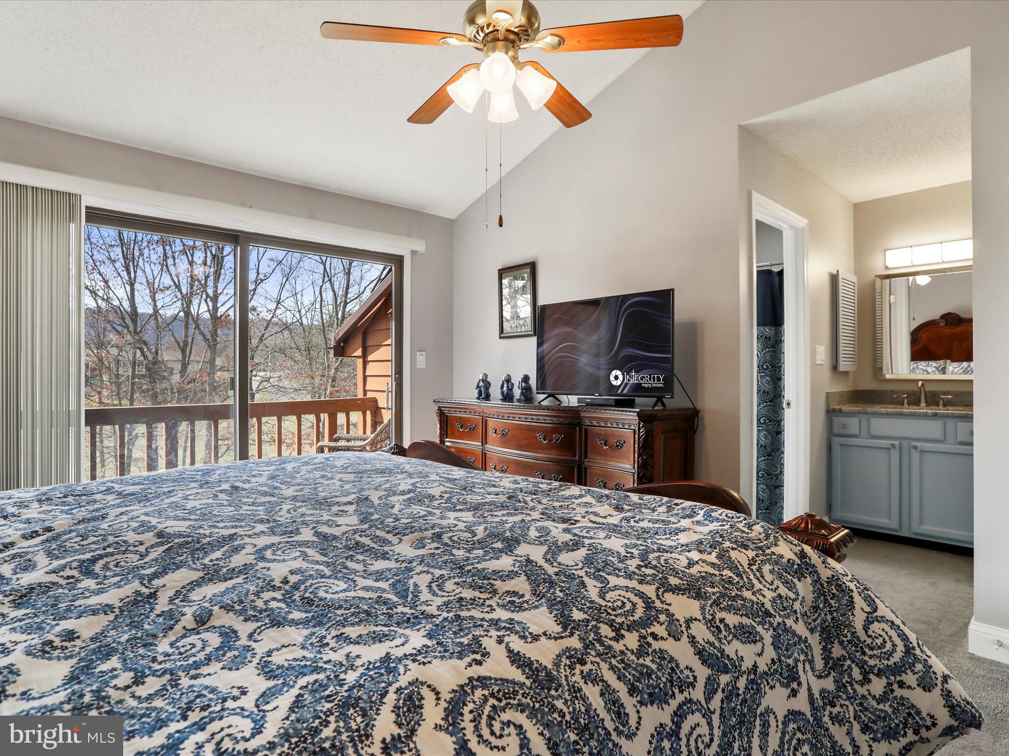 205 Tecumseh Trail Hedgesville, WV 25427 - Photo 23 of 75 a bedroom with a bed a dresser and flat screen tv