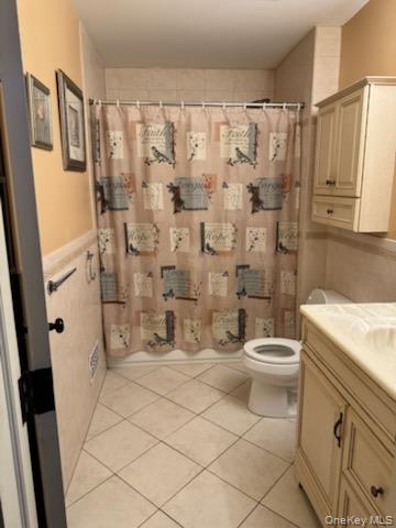 23 Notingham Circle, Unit 23 Peekskill, NY 10566 - Photo 12 of 12 Bathroom featuring vanity, light tile patterned floors, and curtained shower