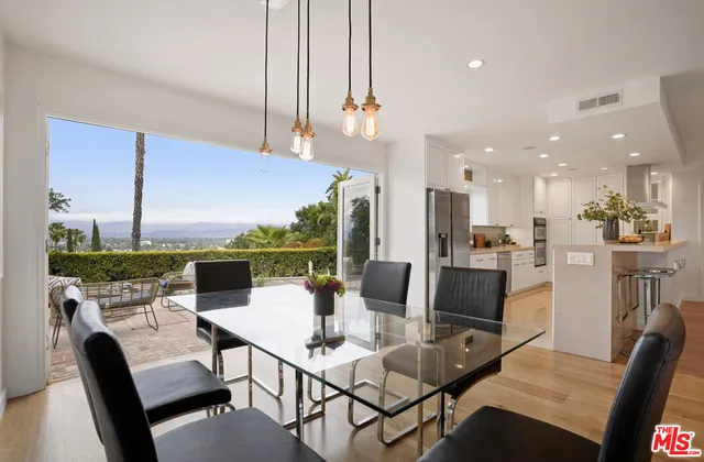 a bedroom with a bed and a couch next to a window
