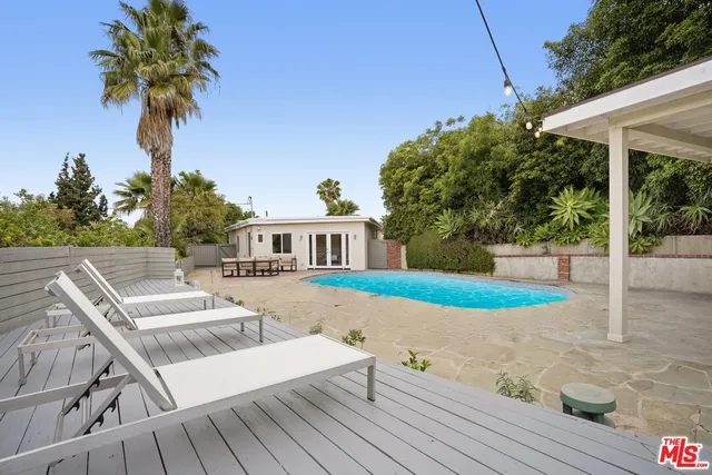 an aerial view of residential house with outdoor space and swimming pool