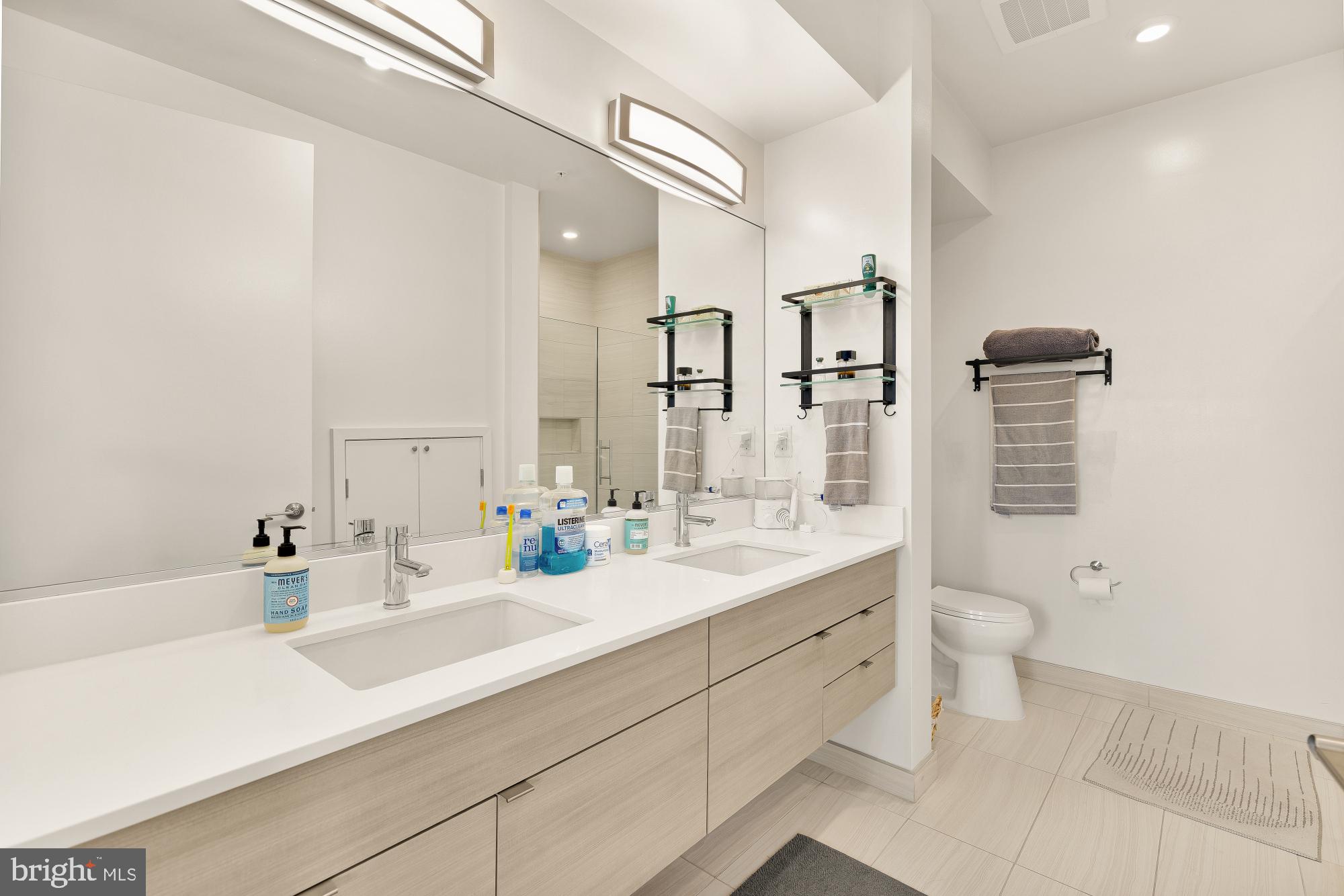 1550 11th Street Northwest, Unit 401 Washington, DC 20005 - Photo 12 of 18 a bathroom with a sink double vanity and a toilet