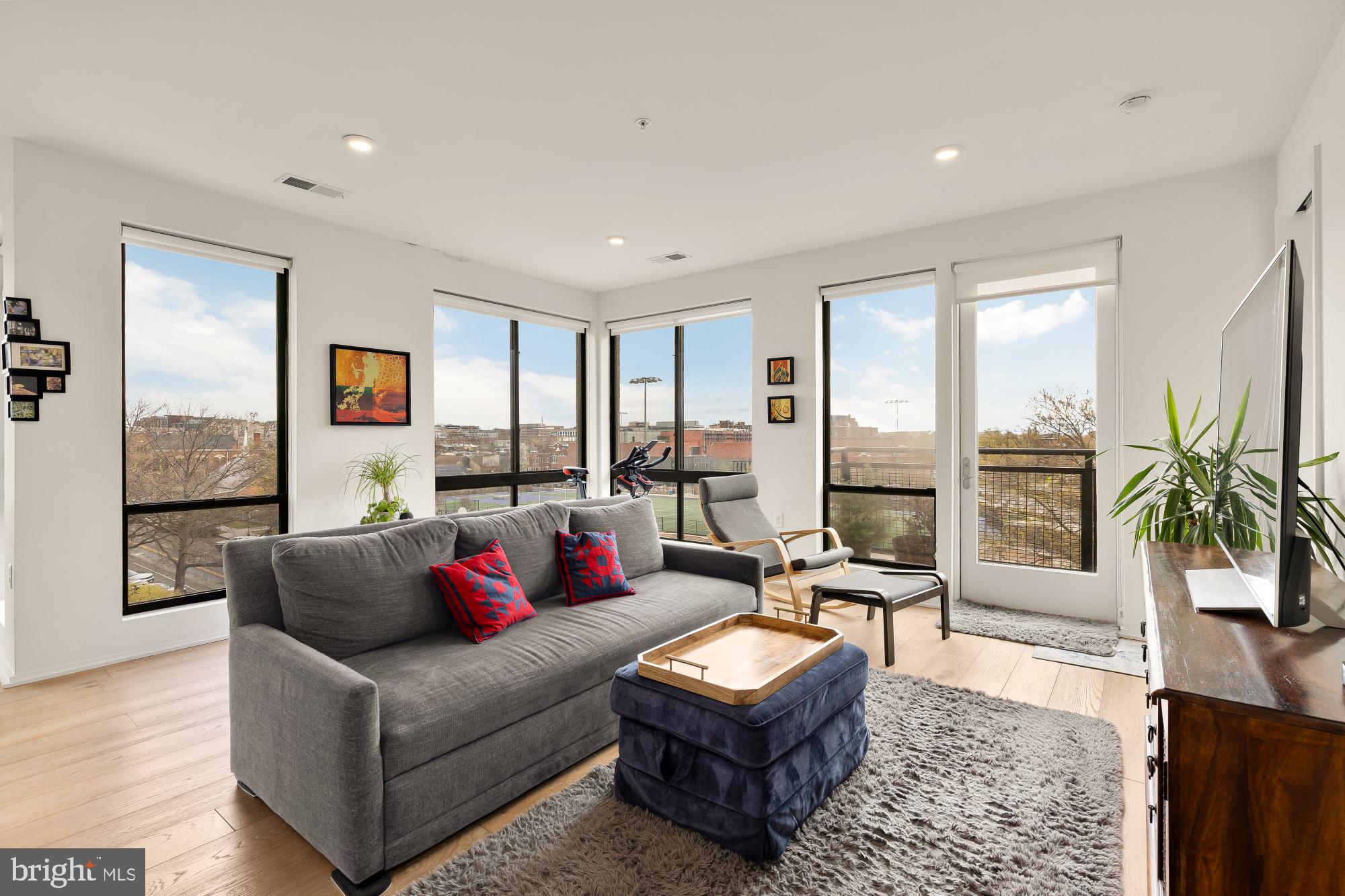 1550 11th Street Northwest, Unit 401 Washington, DC 20005 - Photo 2 of 18 a living room with furniture and a large window