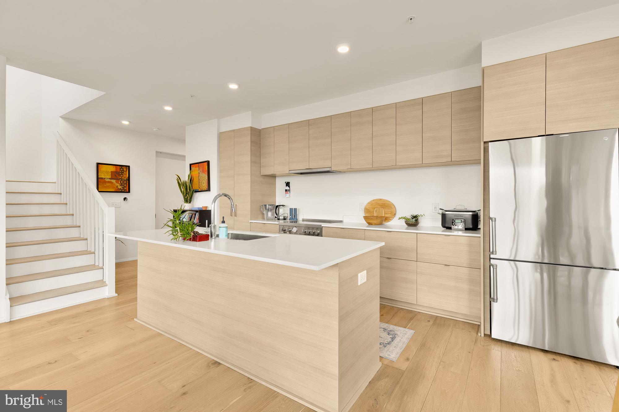 1550 11th Street Northwest, Unit 401 Washington, DC 20005 - Photo 5 of 18 a kitchen with stainless steel appliances a refrigerator sink and cabinets