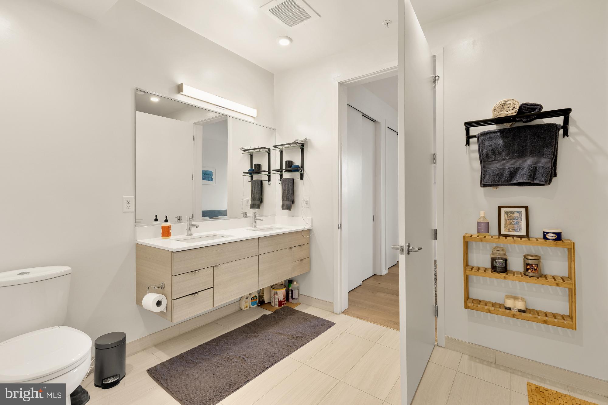 1550 11th Street Northwest, Unit 401 Washington, DC 20005 - Photo 7 of 18 a bathroom with a sink mirror vanity and toilet