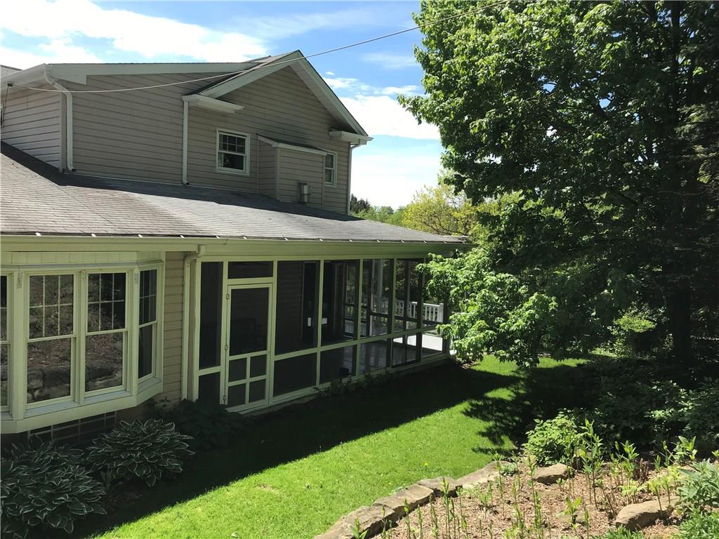 4096 Glasgow Road Valencia, PA 16059 - Photo 8 of 25 Screened in porch with three accesses to this little piece of heaven Over look the landscaped hill side with many plants for the monarch butterflies to spread their wings! Even a pet door built into the screen!