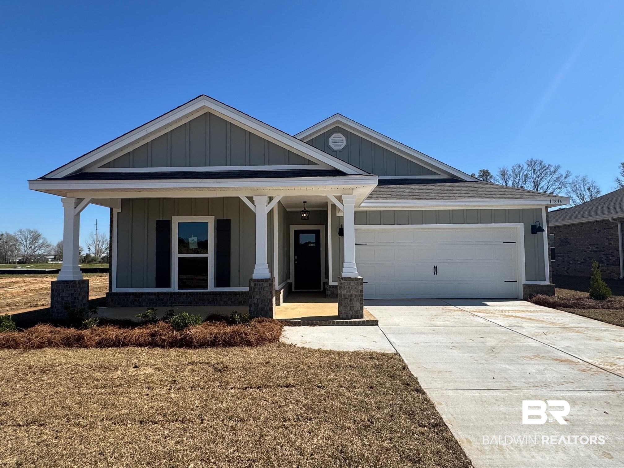 17836 Hens Avenue Foley, AL 36535 - Photo 1 of 30 View of front of home with board and batten siding, a garage, concrete driveway, and covered porch