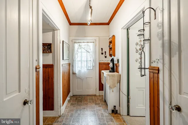 a bedroom with a bed and a large mirror on a dresser
