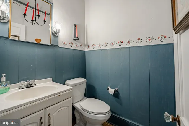 a bedroom with a bed a table and chair with window