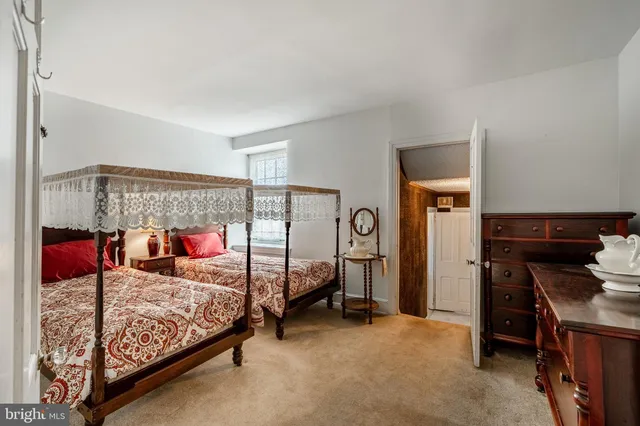 a bedroom with a bed and a ceiling fan