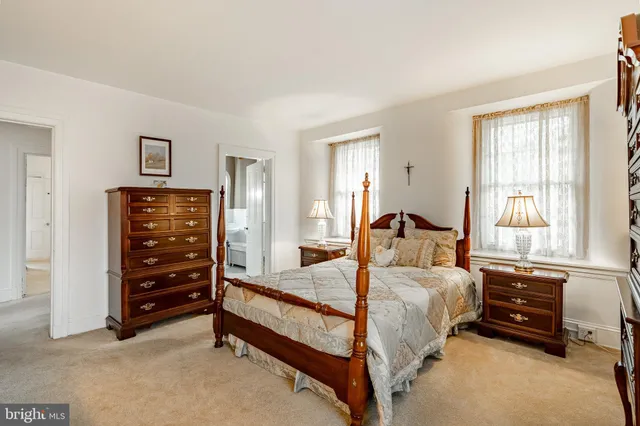 a spacious bedroom with two bed and a window