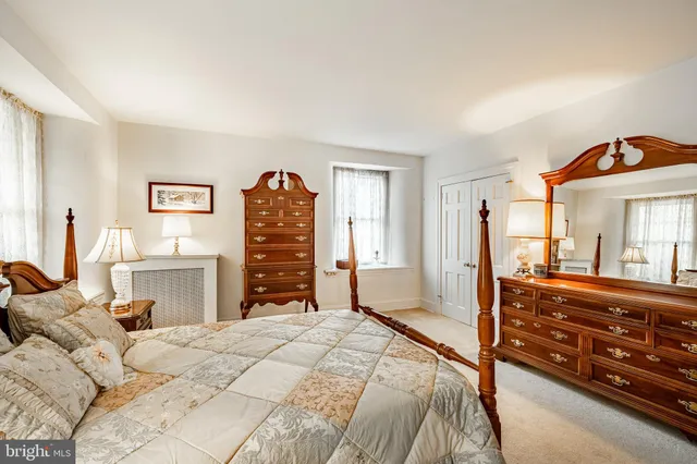 a bedroom with a bed and a ceiling fan