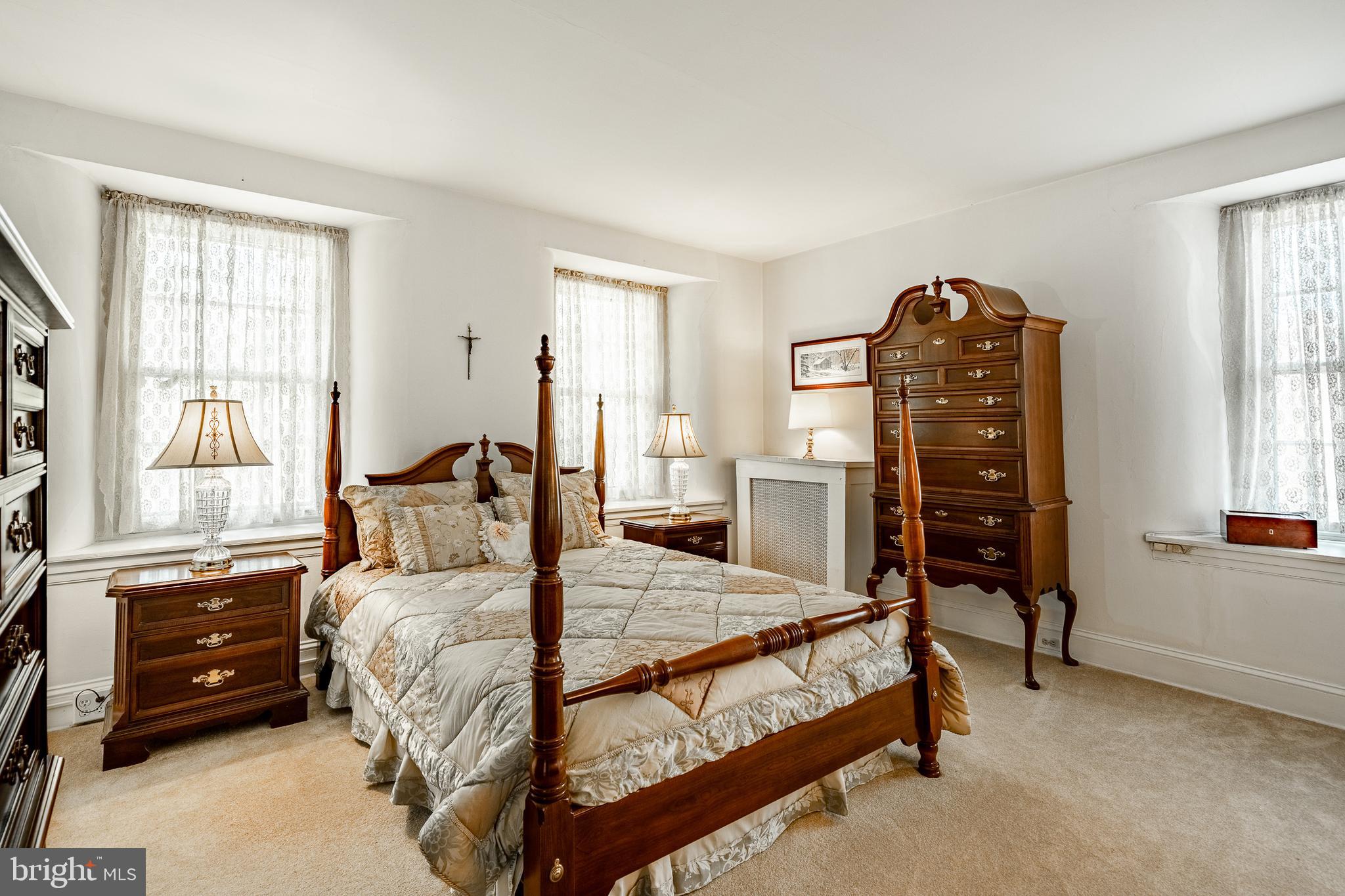 51 Scott Road Glen Mills, PA 19342 - Photo 41 of 85 a bedroom with a bed a table and three windows