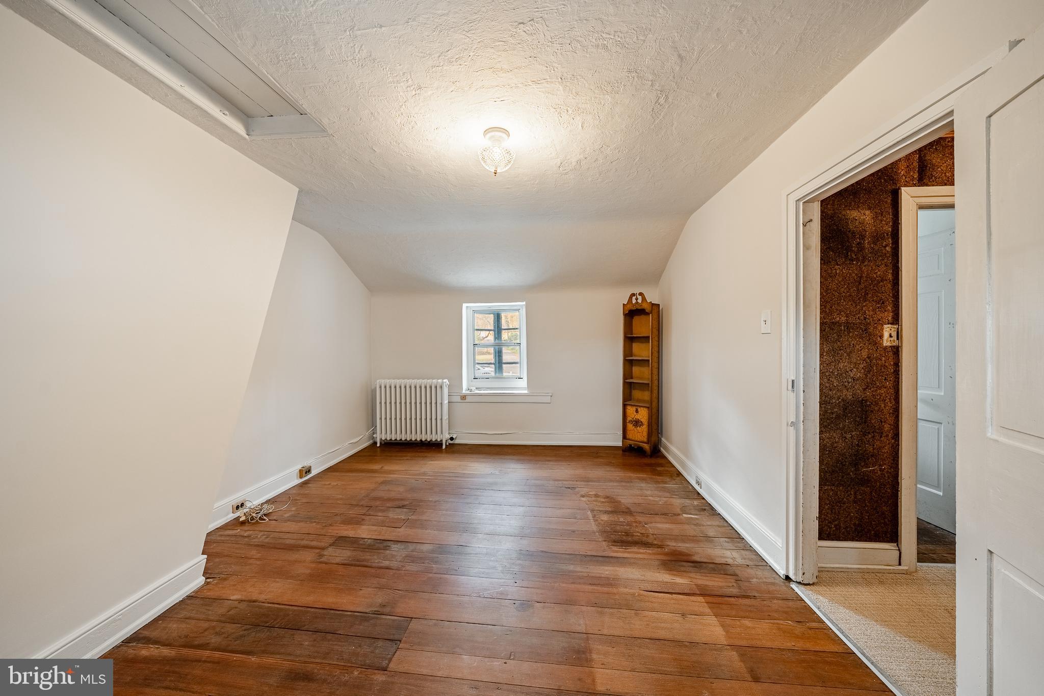 51 Scott Road Glen Mills, PA 19342 - Photo 51 of 85 a view of an empty room with window and wooden floor