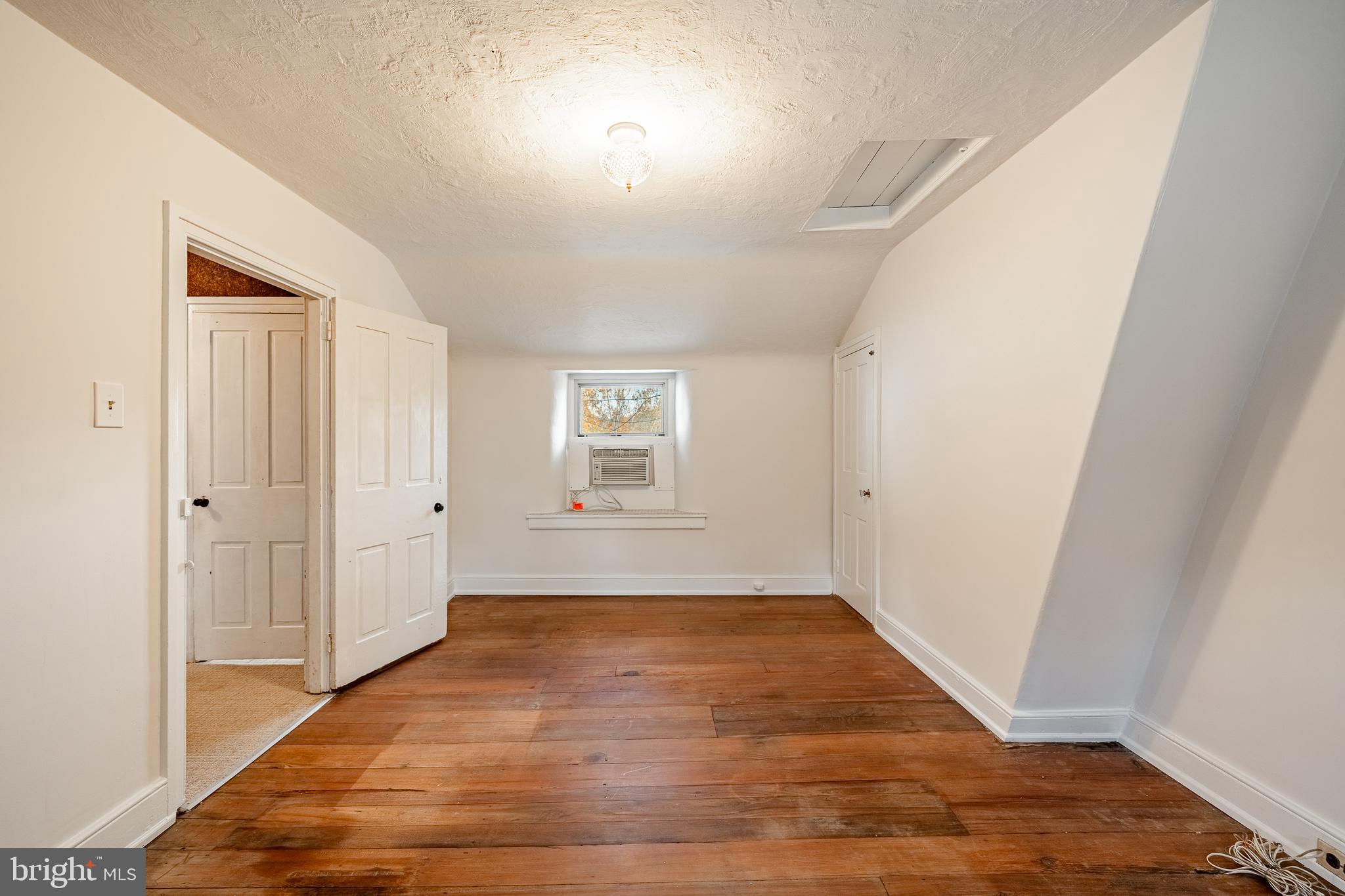 51 Scott Road Glen Mills, PA 19342 - Photo 52 of 85 a view of an empty room with wooden floor and a window