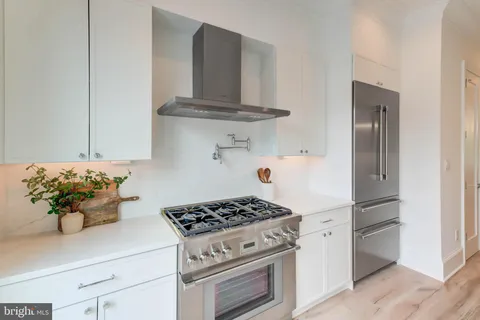 a kitchen with stainless steel appliances a stove and a refrigerator