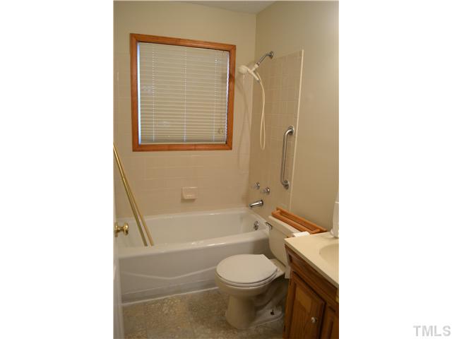505 Solar Drive Raleigh, NC 27610 - Photo 13 of 16 a bathroom with a toilet and a bathtub