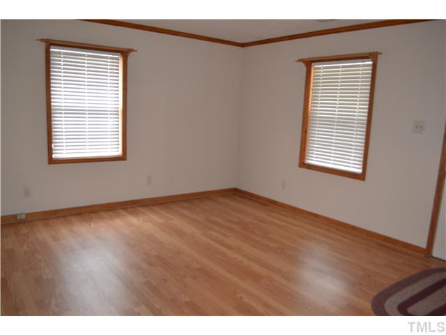 505 Solar Drive Raleigh, NC 27610 - Photo 2 of 16 a view of an empty room with wooden floor and a window