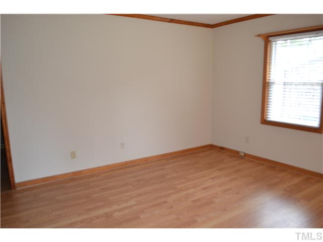 505 Solar Drive Raleigh, NC 27610 - Photo 3 of 16 a view of an empty room with wooden floor and a window