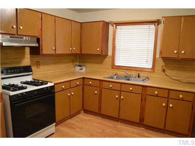505 Solar Drive Raleigh, NC 27610 - Photo 5 of 16 a kitchen with stainless steel appliances granite countertop a stove a sink and a microwave