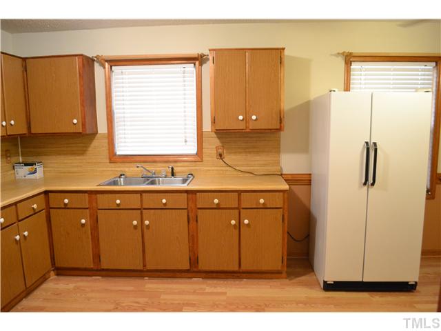 505 Solar Drive Raleigh, NC 27610 - Photo 6 of 16 a kitchen with a refrigerator sink and cabinets