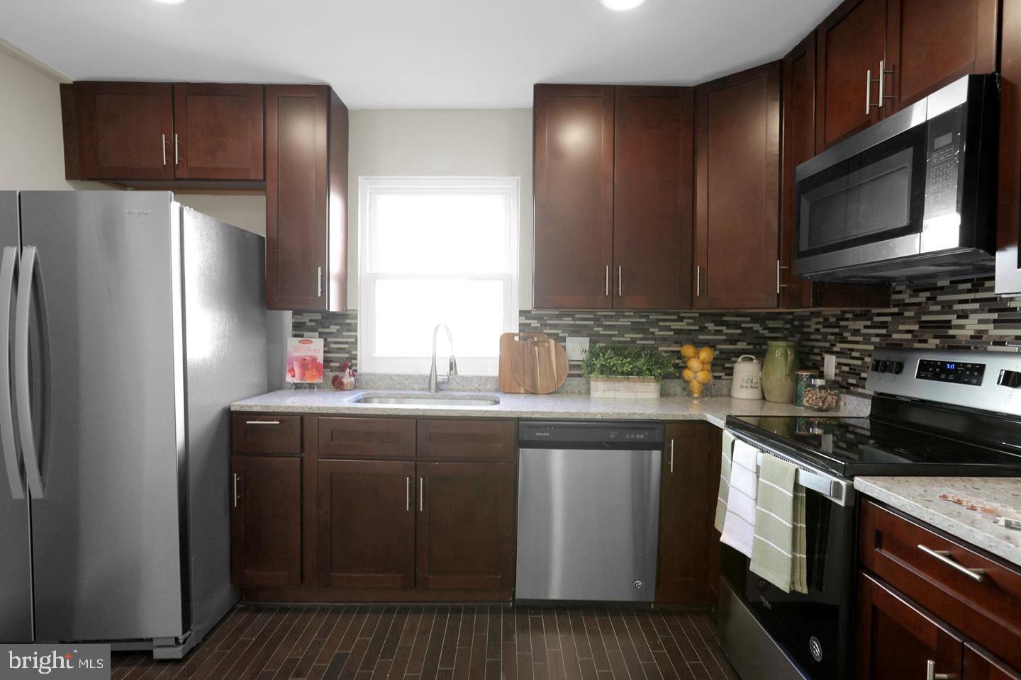 203 Sollers Point Road Dundalk, MD 21222 - Photo 5 of 16 Modern kitchen with rich cabinetry.