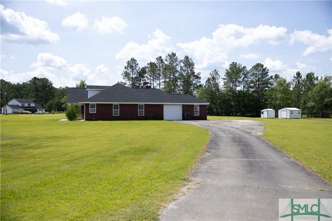306 Main Trail Midway, GA 31320 - Photo 29 of 36 Right side of home with one car garage, 2 storage