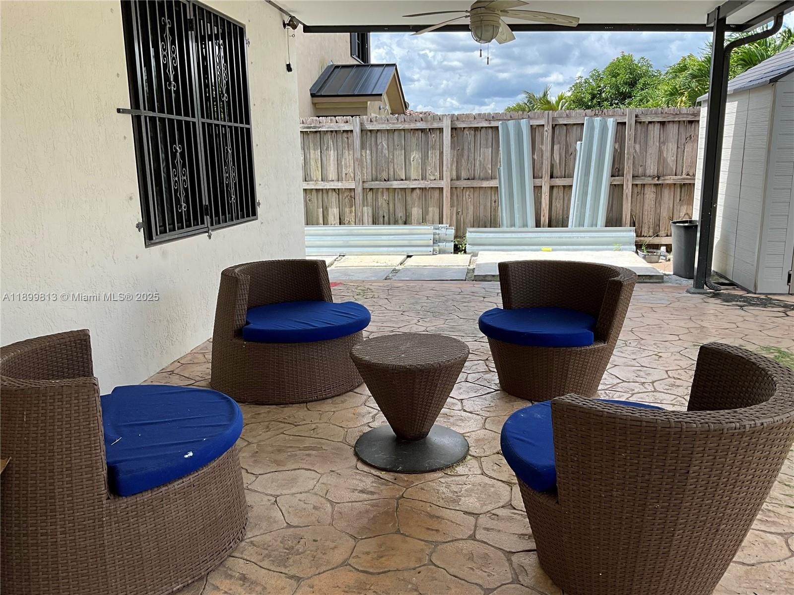 13201 Southwest 274th Terrace Homestead, FL 33032 - Photo 13 of 14 a living room with furniture a rug and a potted plant
