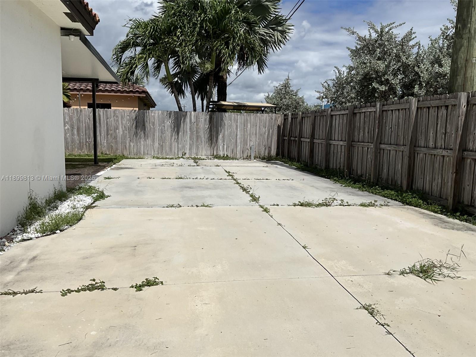 13201 Southwest 274th Terrace Homestead, FL 33032 - Photo 14 of 14 a view of a backyard with wooden fence