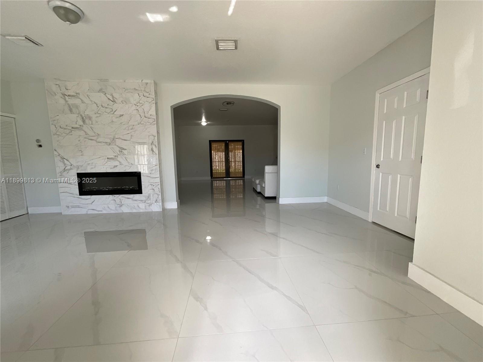 13201 Southwest 274th Terrace Homestead, FL 33032 - Photo 2 of 14 a view of a hallway with a fireplace