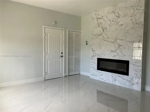 a view of empty room with a fireplace