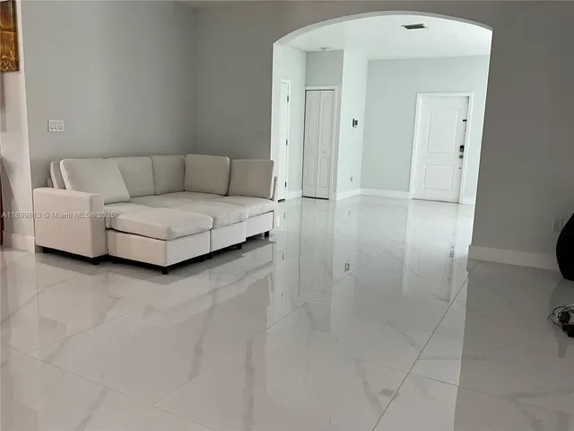 a living room with furniture and a walk in closet