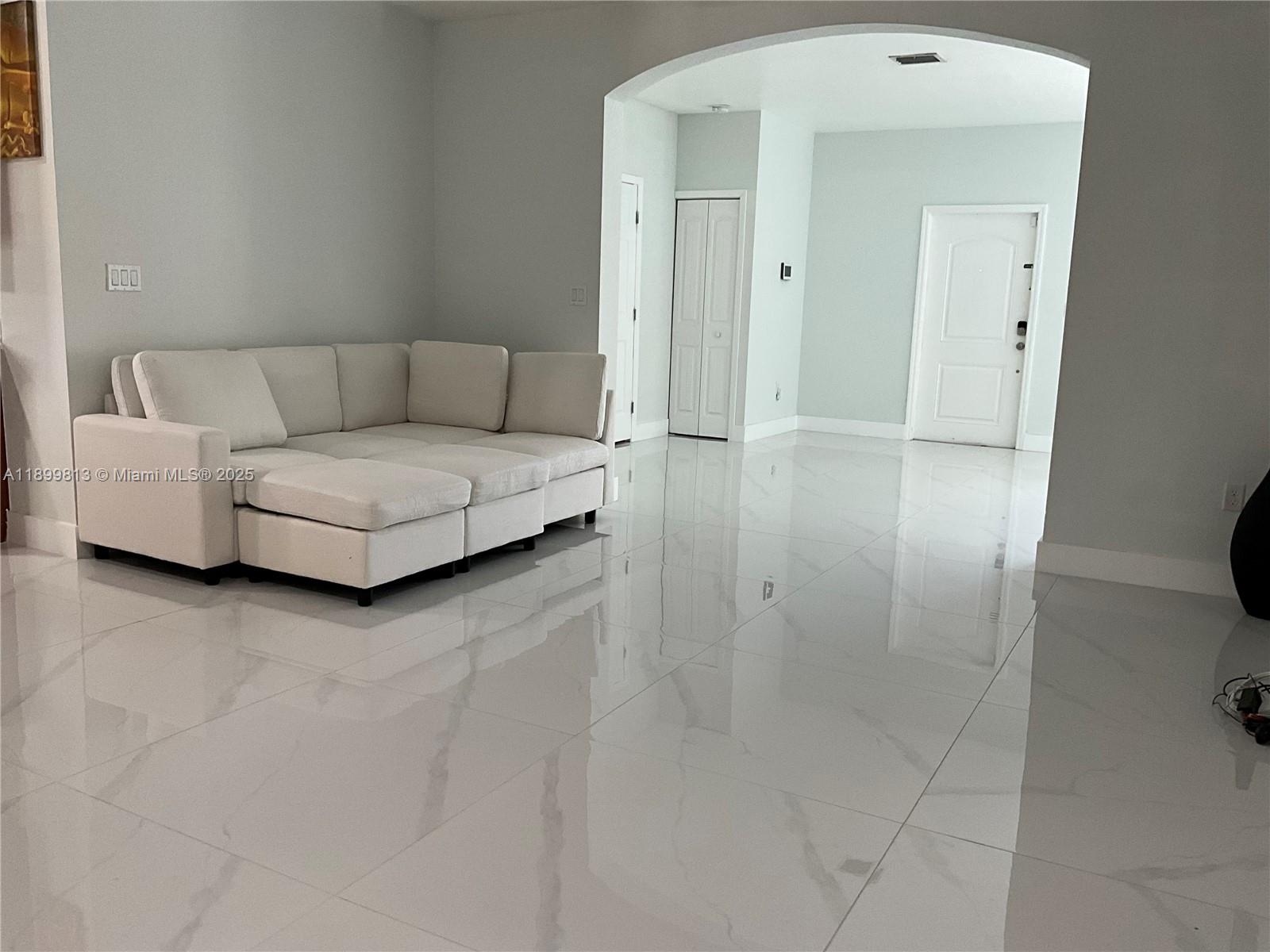 13201 Southwest 274th Terrace Homestead, FL 33032 - Photo 7 of 14 a living room with furniture and a walk in closet