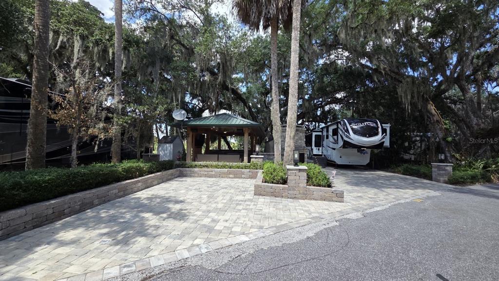 291 Bear Trail River Ranch, FL 33867 - Photo 3 of 23 a view of a backyard with table and chairs and a fire pit