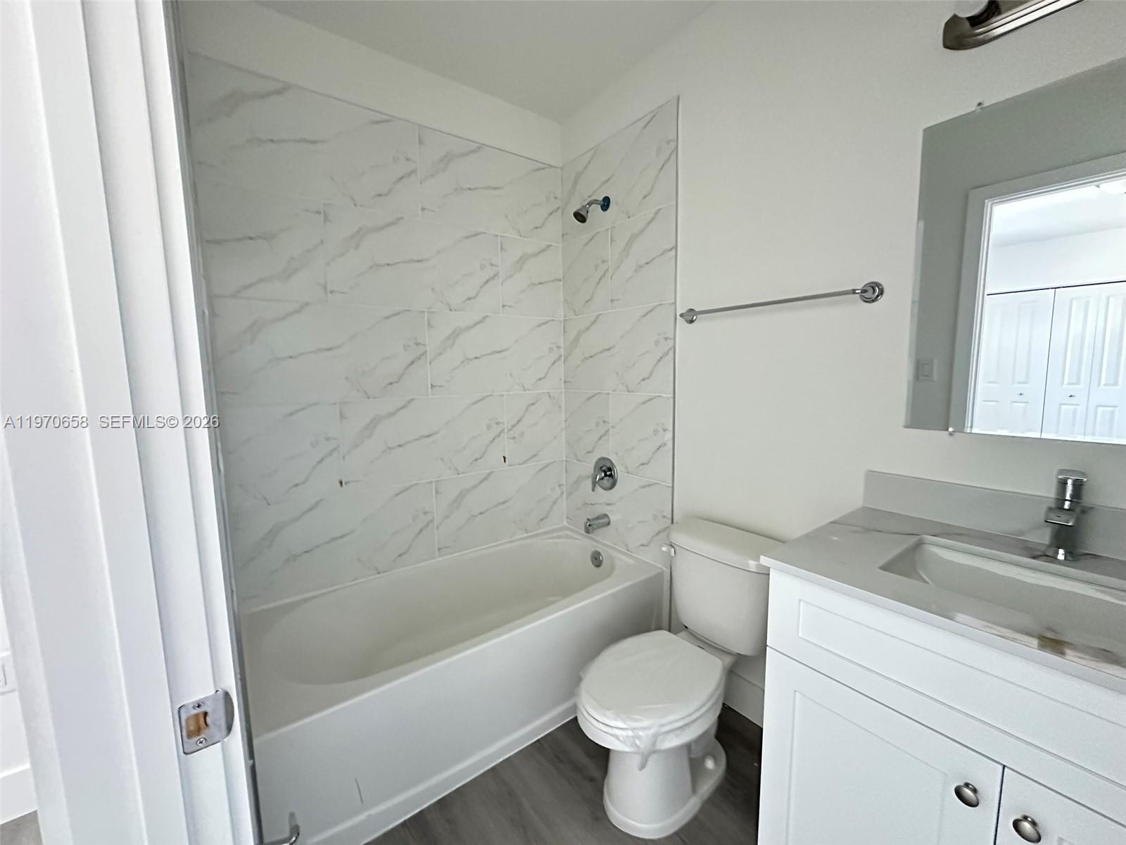 11278 Southwest 187th Street, Unit 11278 Miami, FL 33157 - Photo 13 of 16 a bathroom with a sink toilet and shower
