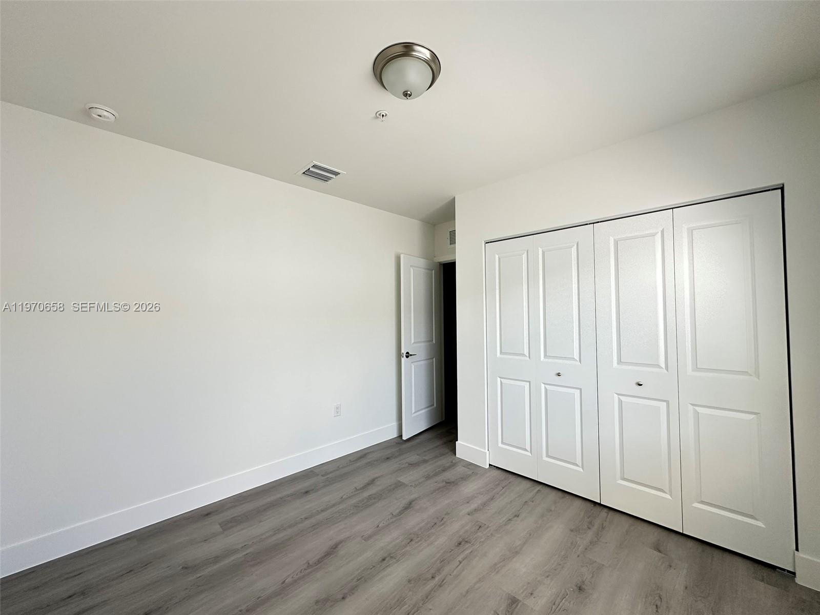 11278 Southwest 187th Street, Unit 11278 Miami, FL 33157 - Photo 10 of 16 a view of an empty room with wooden floor