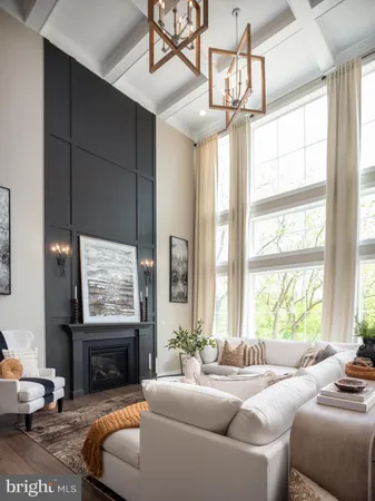 a living room with furniture a chandelier and a large window