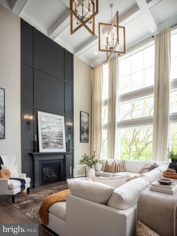 a living room with furniture a chandelier and a large window