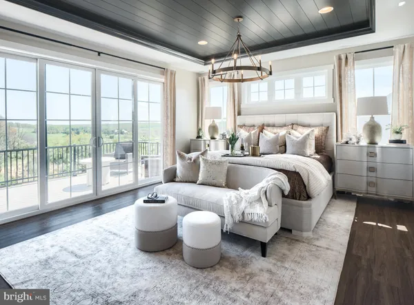 a bedroom with furniture and a large window