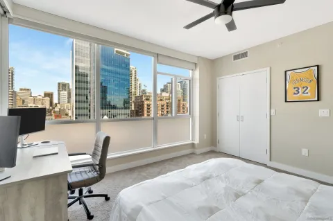 a view of a workspace with furniture and a window