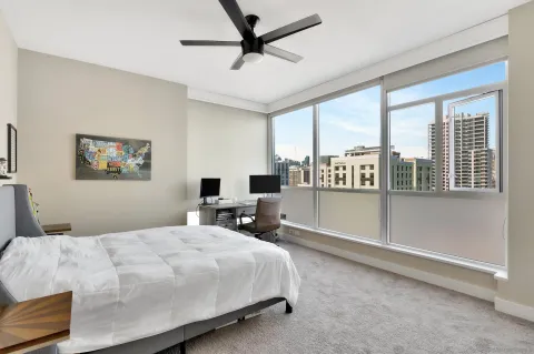 a bedroom with a large bed and a large window