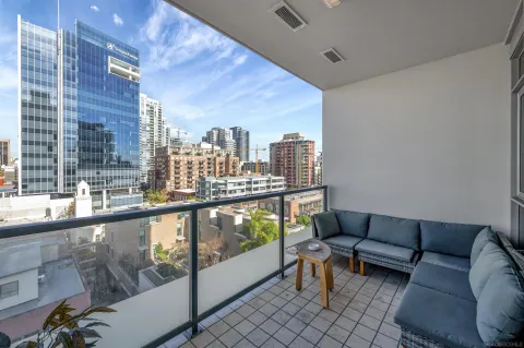 a living room with furniture and a floor to ceiling window