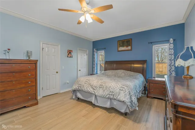 a bedroom with a bed and wooden floor