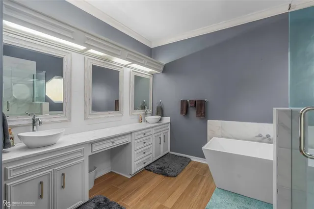 a bathroom with a double vanity sink mirror and toilet