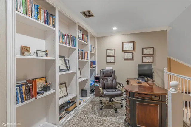 a view of a workspace with furniture and a book shelf