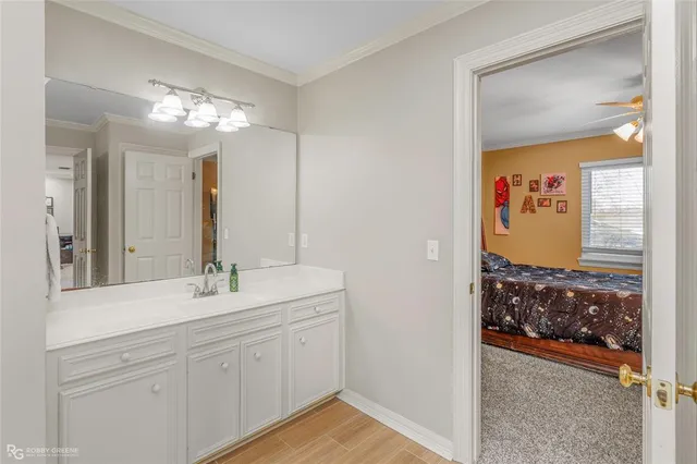 a en suite bathroom with a sink a mirror and a shower