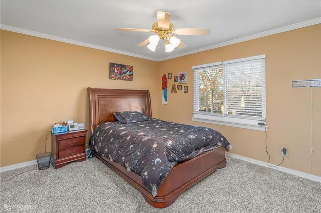 a bed sitting in a bedroom next to a window